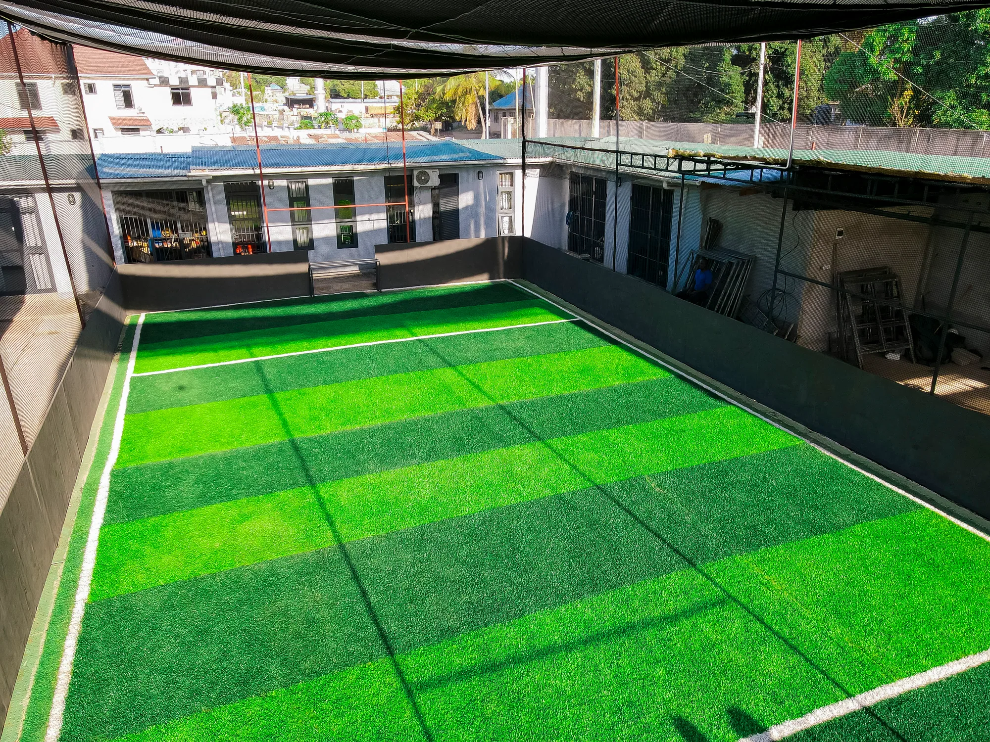 Striped artificial turf and white pitch markings at Kibada Soccer Pitch